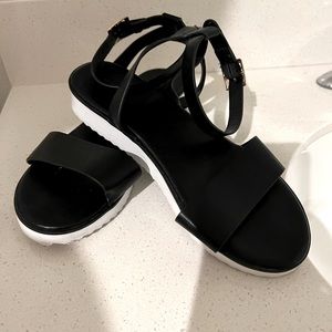 Flat black faux leather sandal